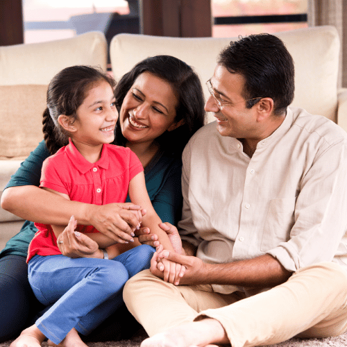 Happy Indian family smiling with their child, symbolizing the benefits of parenting online consultation for stronger family bonds.